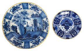 An Dutch Delft blue and white charger and a 'Peacock' plate
