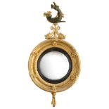 A Regency giltwood and gesso convex wall mirror