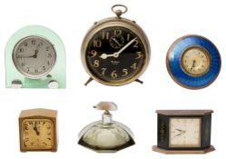 A 1930s enamel and brass alarm clock, five others