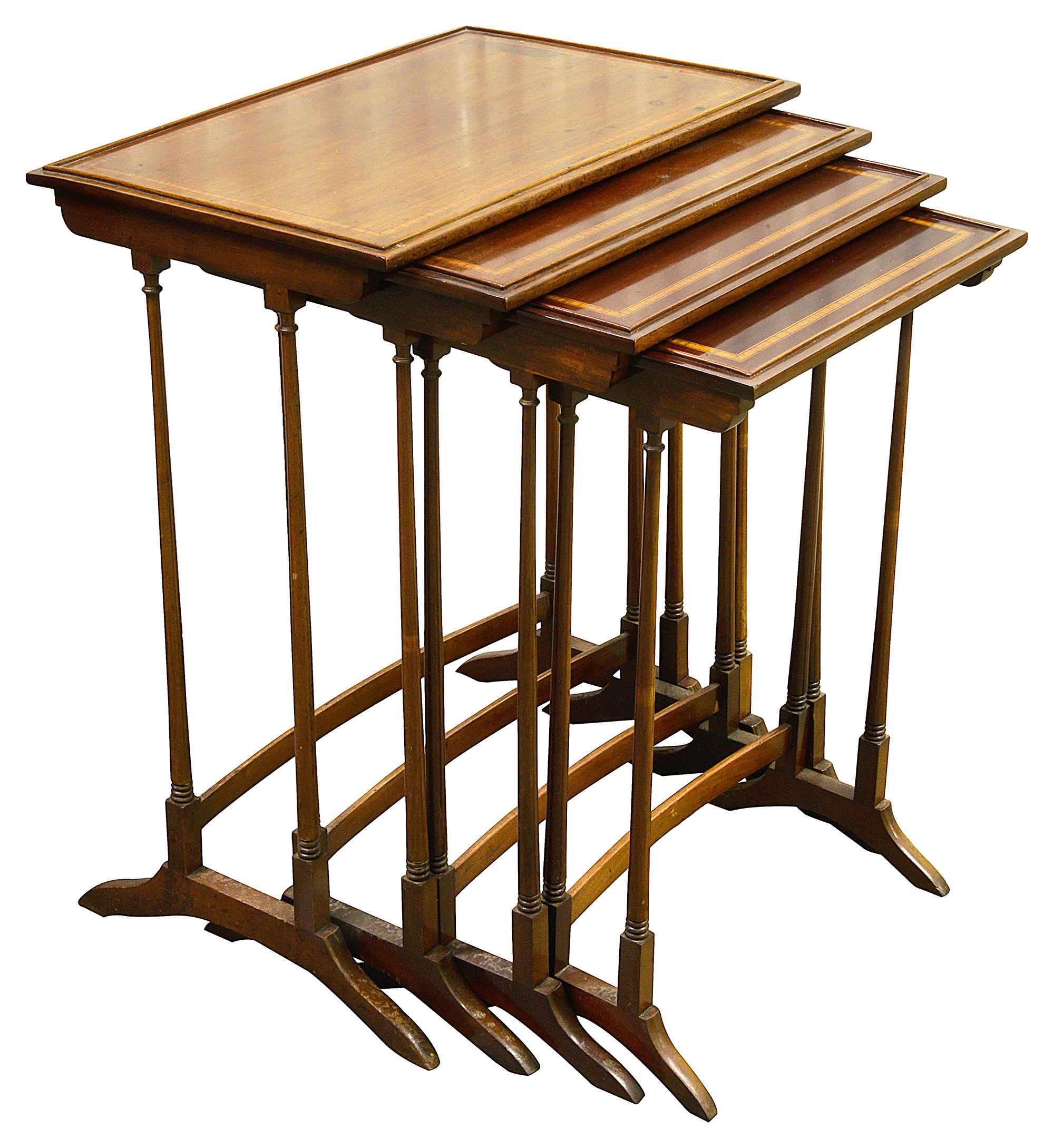 An Edwardian nest of four mahogany occasional tables