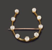 A diamond horseshoe brooch