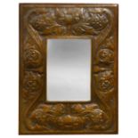 An Arts & Crafts repousse embossed copper and oak wall mirror