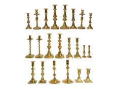 A pair of George II candlesticks and ten later 19th century pairs