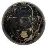 A large black polished Portoro marble sphere