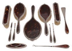 An Edwardian silver and tortoiseshell dressing table and manicure set