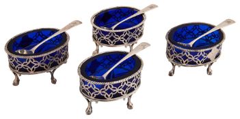 A set of four George III silver salts and a set of salt spoons