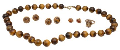 A tiger's eye bead necklace and a pair of ear studs