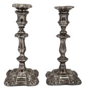 A pair of silver plated candlesticks in George II style