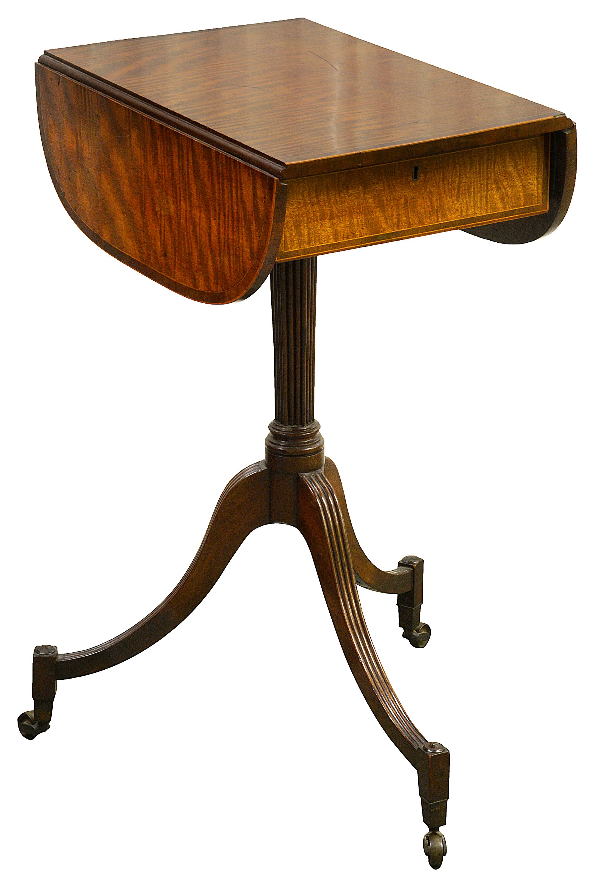 A small George III mahogany oval pedestal Pembroke table