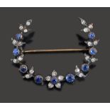 A sapphire and diamond crescent brooch