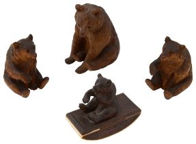 Three Swiss Black Forest linden wood carvings of bears and a desk blotter