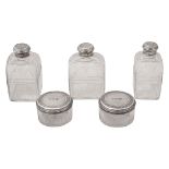 Five George IV silver mounted cut glass toilet bottles and jars