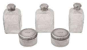 Five George IV silver mounted cut glass toilet bottles and jars