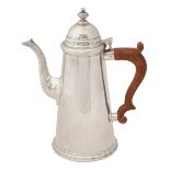 A modern silver coffee pot in early 18th century style