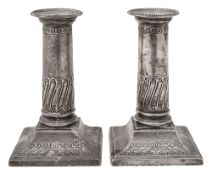 A pair of Edwardian silver dwarf column candlesticks