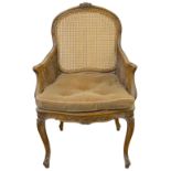 A Louis XV style beechwood and caned bergere