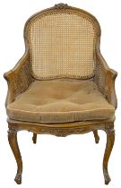 A Louis XV style beechwood and caned bergere