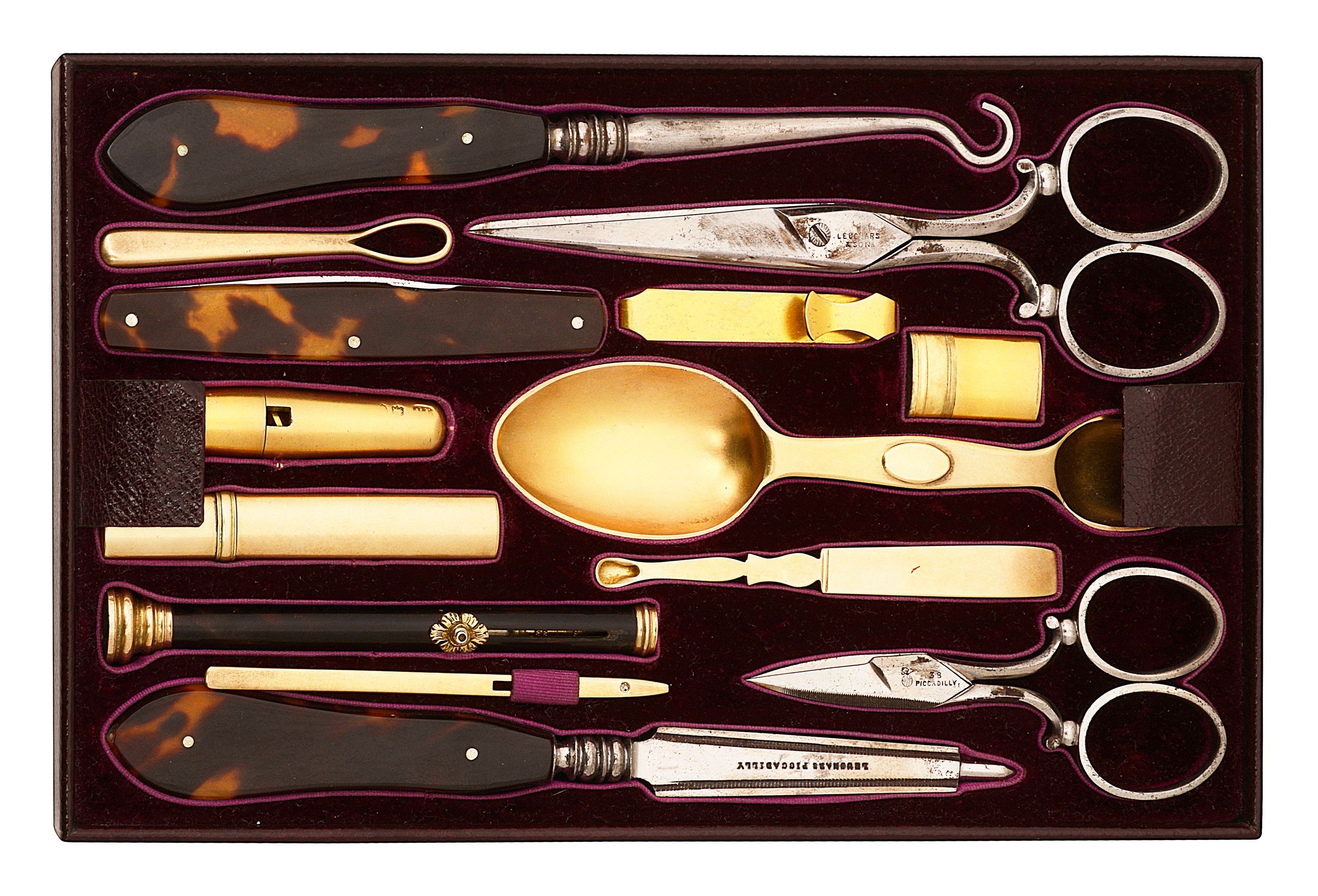 A mid Victorian fitted tray of silver-gilt tools from a dressing box
