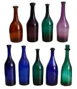 A collection of early 19th century coloured glass bottle shaped decanters