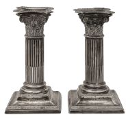 A pair of late Victorian silver dwarf Corinthian column candlesticks