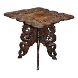 A Kashmiri carved hardwood occasional table.