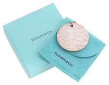 A 'Notes' disc pendant by Tiffany & Co.
