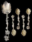 A set four Victorian cast silver salt spoons and a serving spoons