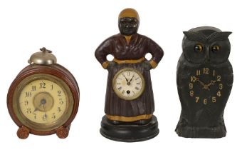 A carved wood novelty owl clock and two others.