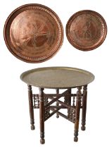 An Indian brass topped folding table, and two trays.
