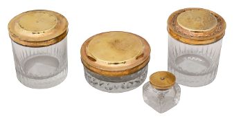 Three late 18th century French silver-gilt lidded cut glass toilet jars and and a inkwell