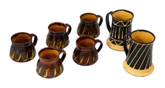 Two Arch pottery tankards and 5 smaller mugs