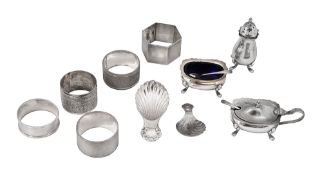 A silver three piece cruet set, two caddy spoons and assorted napkin rings