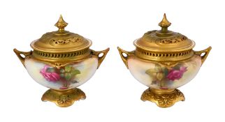 A near pair of Royal Worcester twin handled pot pourri vases and covers