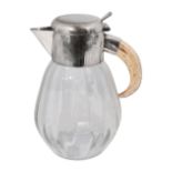 A German electroplate mounted glass lemonade jug with boar tusk handle