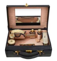 A George VI leather dressing case with silver fittings