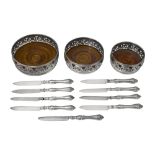 A graduated set of 3 silver plated WMF coasters, and six plated knives