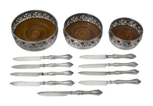 A graduated set of 3 silver plated WMF coasters, and six plated knives