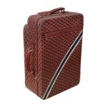 A red trolley rolling suitcase by Goyard