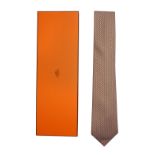 A pale blue and orange Hermes silk tie