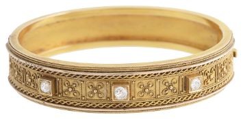 An Etruscan revival diamond set gold bangle