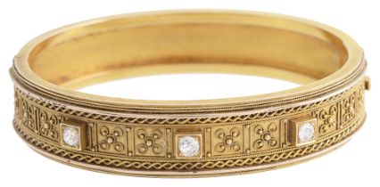 An Etruscan revival diamond set gold bangle