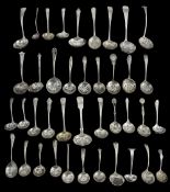 A collection of late Victorian, Edwardian and later silver sifter spoons