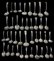 A collection of late Victorian, Edwardian and later silver sifter spoons