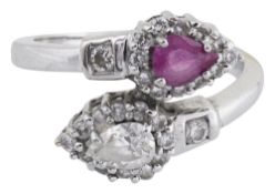 A diamond and pink sapphire cross-over ring