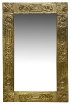 An Arts and Crafts brass embossed mirror