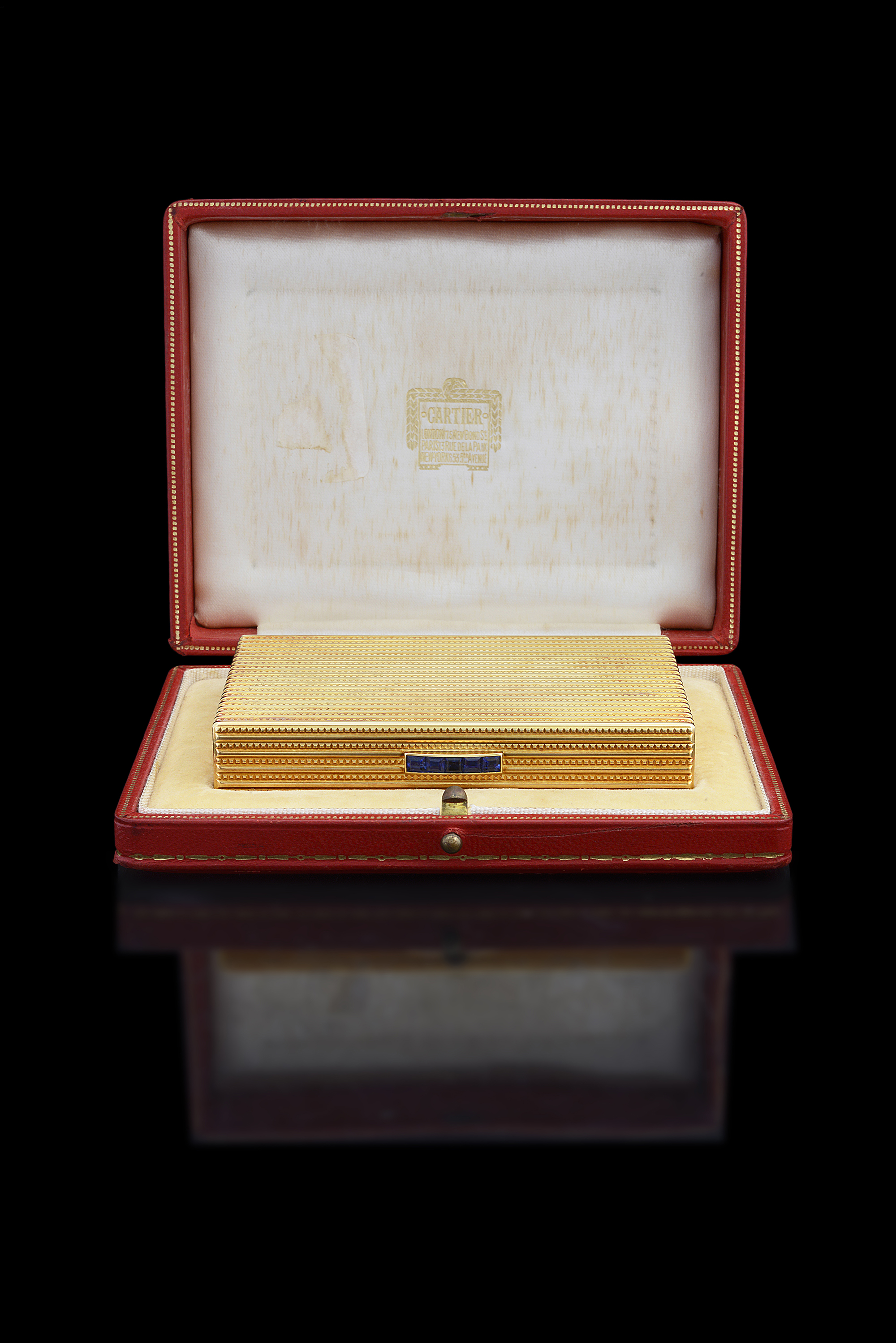 An 18ct gold and sapphire Cartier cigarette case in fitted case