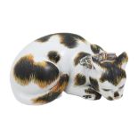 A Japanese kutani porcelain figure of a recumbent sleeping cat