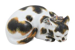 A Japanese kutani porcelain figure of a recumbent sleeping cat
