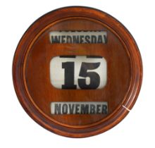 An early 20th century mahogany perpetual wall calendar