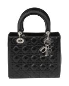 A Christian Dior black patent leather medium Lady Dior bag
